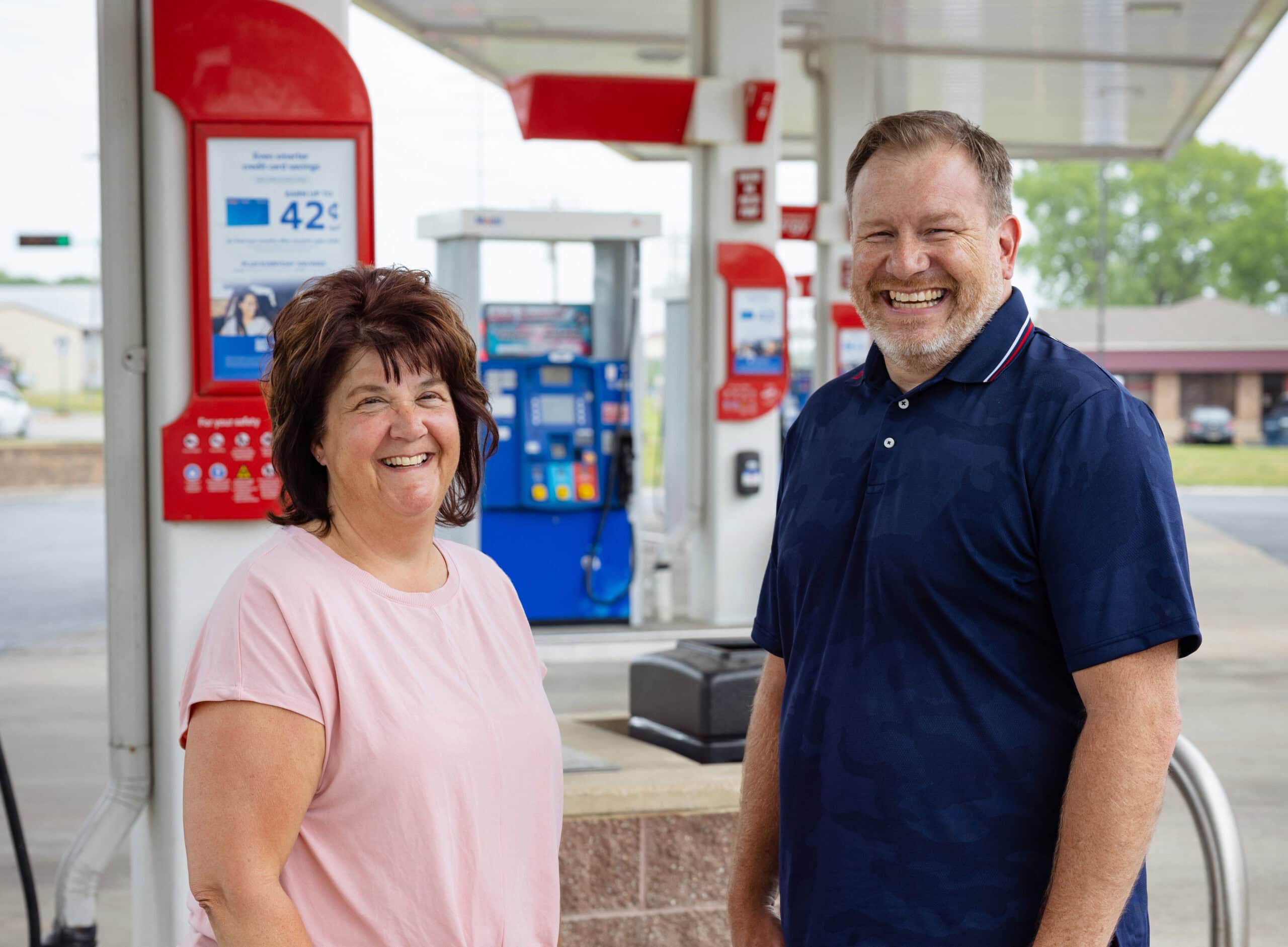Photo of U.S. Energy branded fuel customer account representative standing with one of its retail fueling marketing c-store customers